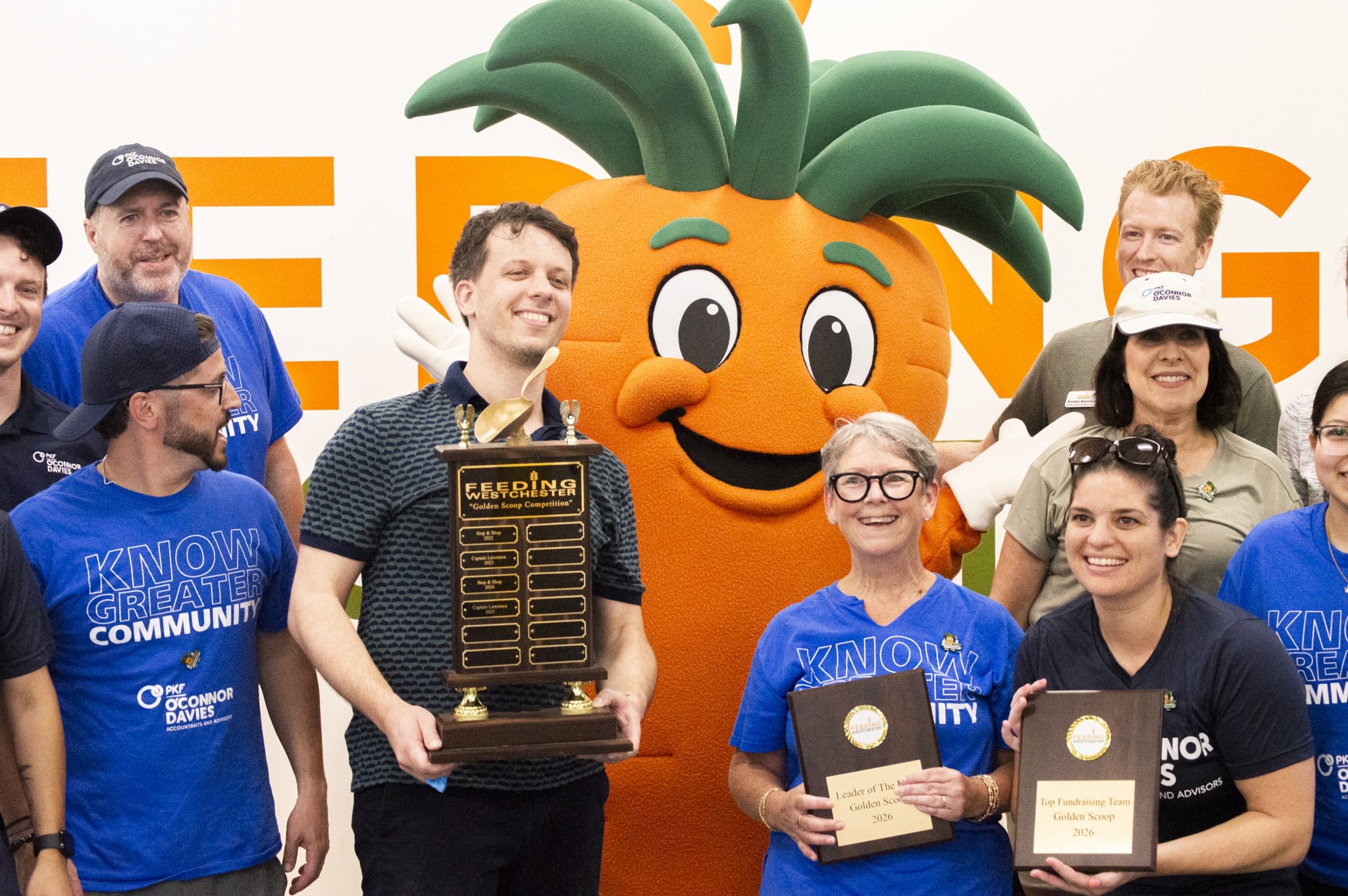 Golden Scoop Competition 2026 winners with the Feeding Westchester carrot mascot and trophy