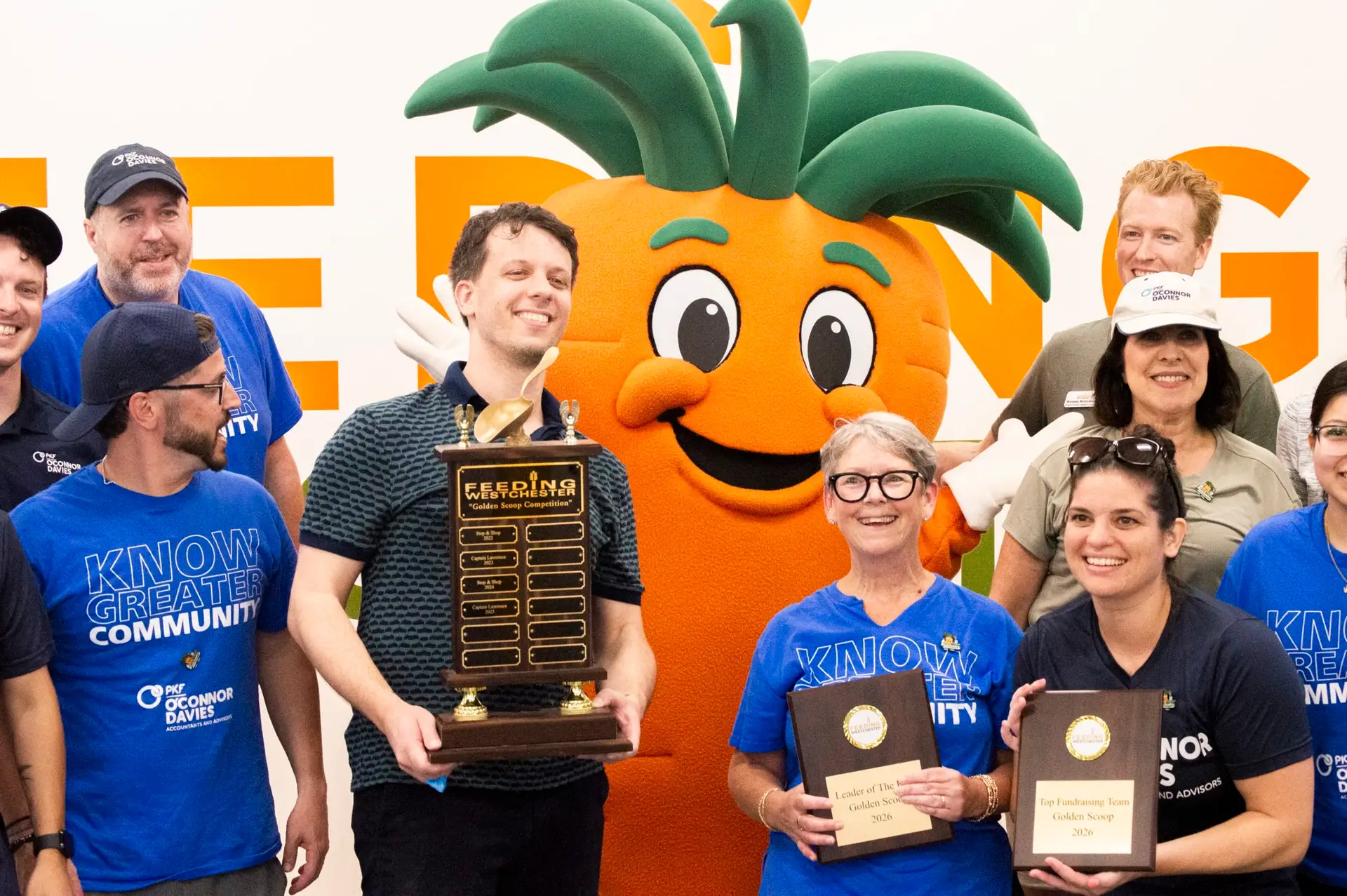 Golden Scoop Competition 2026 winners with the Feeding Westchester carrot mascot and trophy