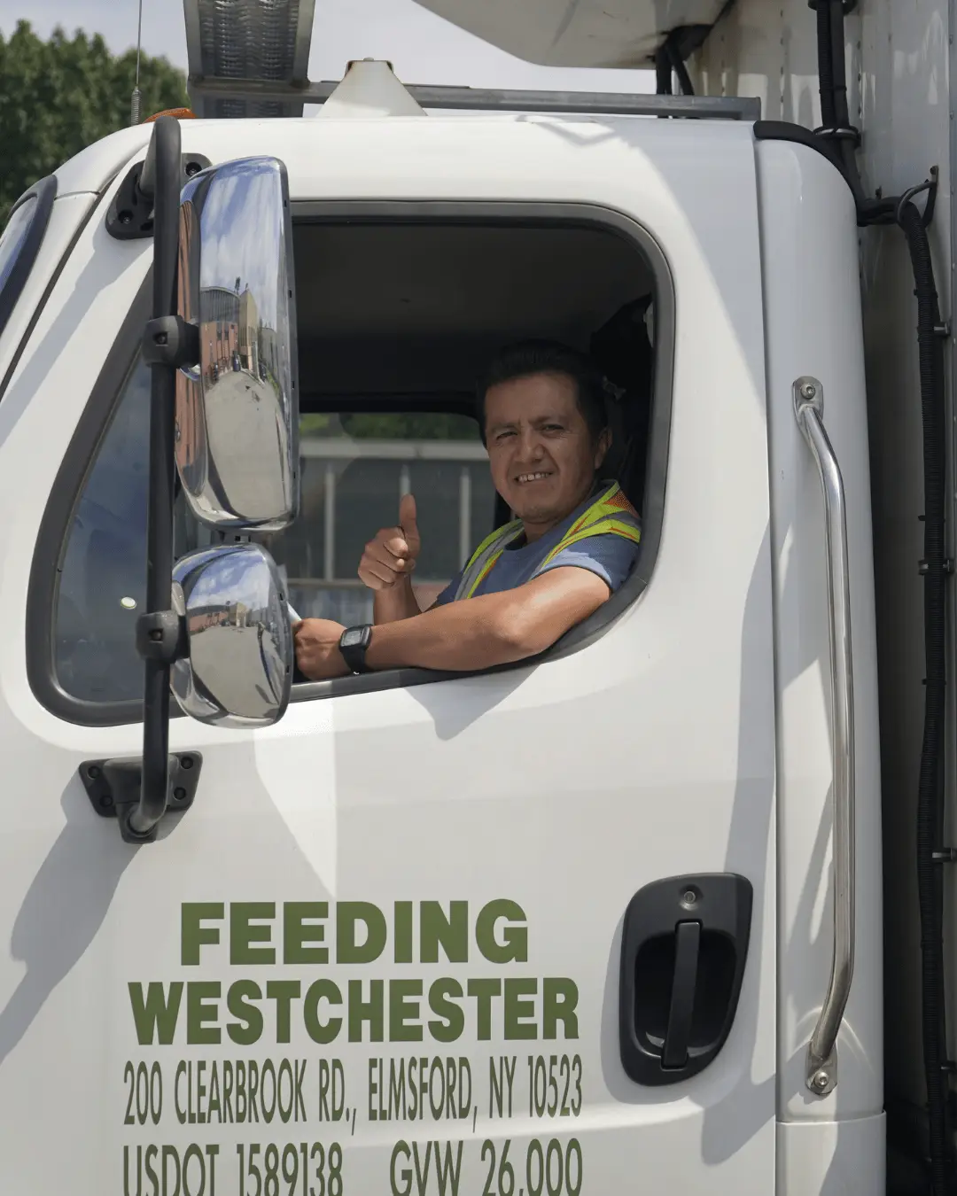 Feeding Westchester driver giving a thumbs up from the delivery truck cab